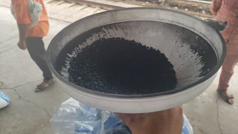 a man's coal is loaded into a large ro vessel through a large funnel to filter the water - water vending machine