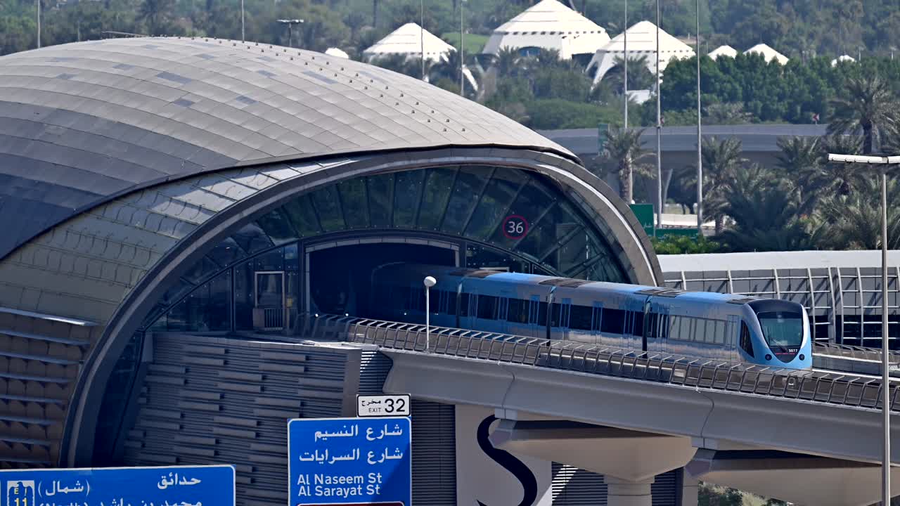 A Dubai Metro train leaves the station, heading to its next stop along Sheikh Zayed Road in Dubai, UAE