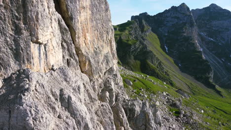 aerial-face-of-Dolomites-mountain-cliff-in-Italian-Alps-on-a-sunny-summer-day