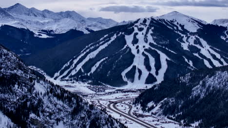 ski runs trails distant i70 copper mountain leadville colorado winter december christmas aerial drone cinematic landscape silverthorne vail aspen ten mile range cloudy rocky mountains slow reveal