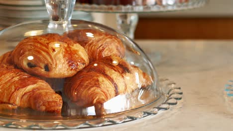 delicious croissants under glass dome