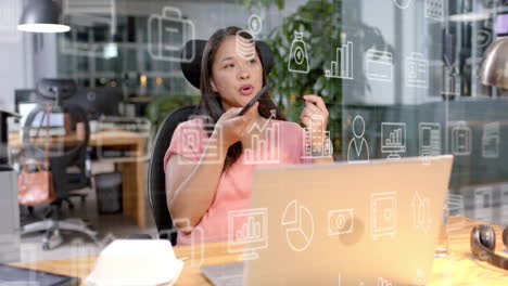 animation of business icons and data processing over biracial businesswoman in office