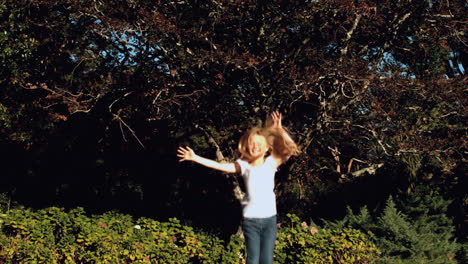 Cheerful-blonde-little-girl-jumping-on-a-trampoline