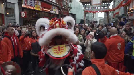 chinese dragon dancer in middle of the crowd in china town london england during new year celebration parade