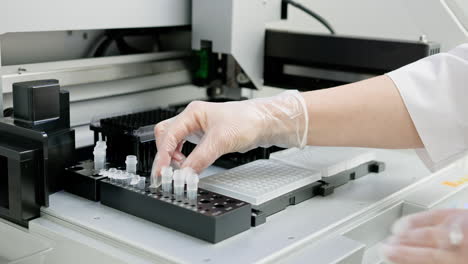 scientist using automated lab equipment for sample preparation