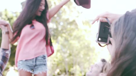 hipster friends taking pictures with an old camera