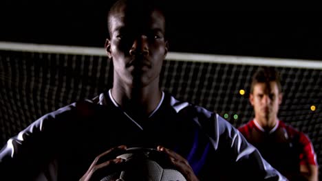 portrait of confident soccer player holding ball with rival athlete 4k