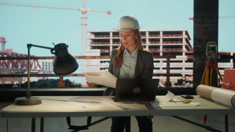 female engineer or architect working at a construction site desk