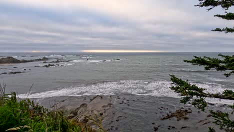 waves roll into the rocky coast of the pacific