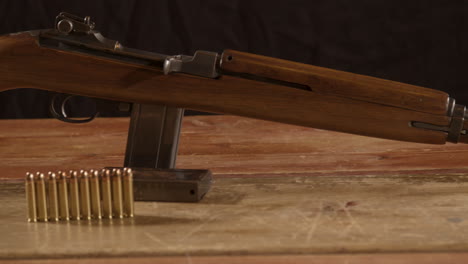 muñeca ancha de rifle de carabina clásico de 30m1 con munición en primer plano sobre una superficie de madera
