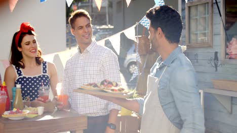 waiter serving food to customers