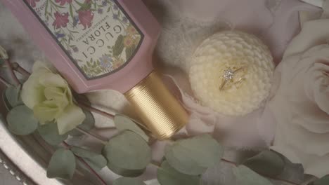 wedding table decor with diamond ring, white roses and luxury beauty care product. marriage concept.