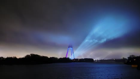 Epic night show with laser beams lighting the cloudy sky above Riga’s Daugava