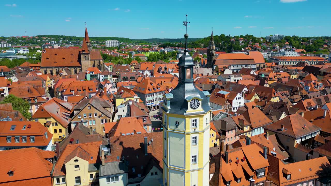 4K Aerial Drone Video of the Historic Herrieder Clock Tower, St. Johannis Church, and St. Gumbertus Church in the Old Town area of Downtown Ansbach, Germany