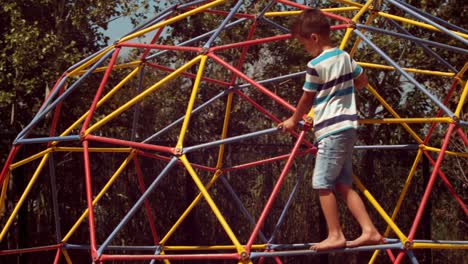 Schoolboy-playing-on-dome-climber