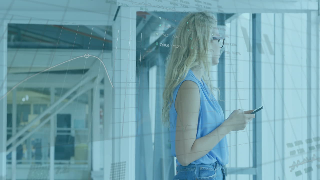 Woman analyzing data on smartphone in modern office, with animated financial charts on glass window