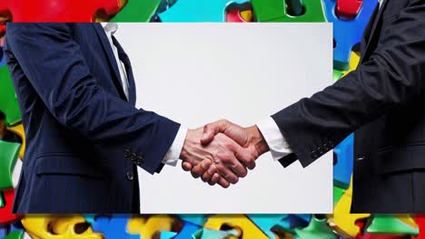 business handshake with puzzle background