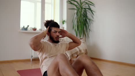 mixed race guy making cross sit ups exercises for the abs