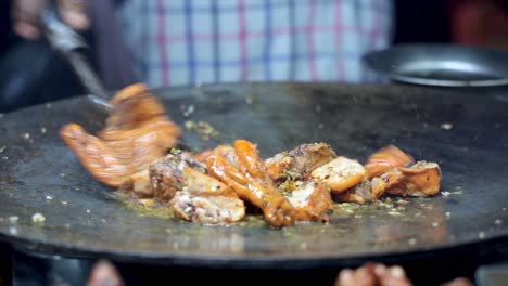 close-up video of chicken sizzling as it's cooked in an asian market