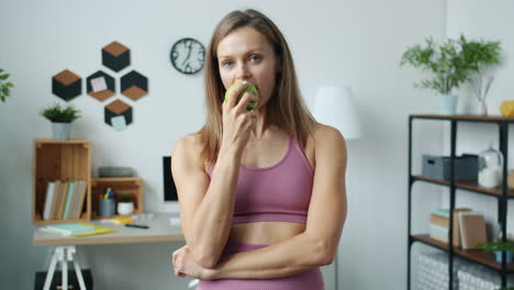 woman eating an apple at home