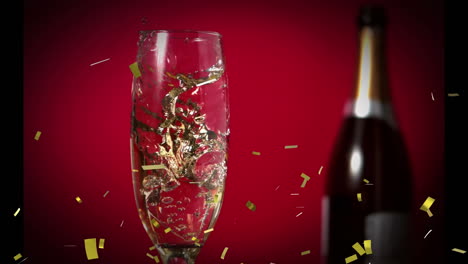 animation of gold confetti falling over glass of champagne