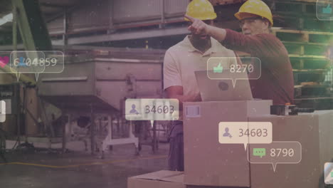 social media engagement animation over factory workers handling boxes and using laptop