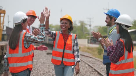 railway engineering group made a high five congratulating colleagues.