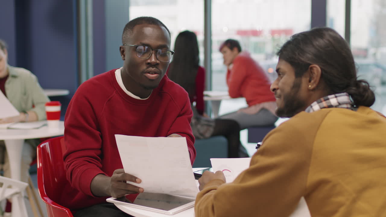 Businesspeople Discussing Work in Office Cafeteria
