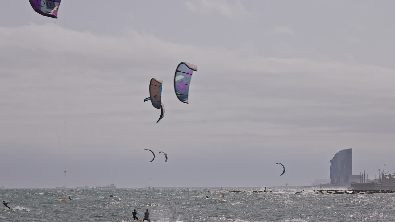 Kitesurfers on a windy day at sea in barcelona