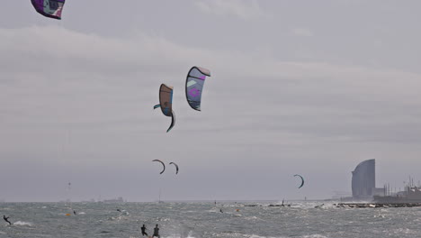 kitesurfers on a windy day at sea in barcelona