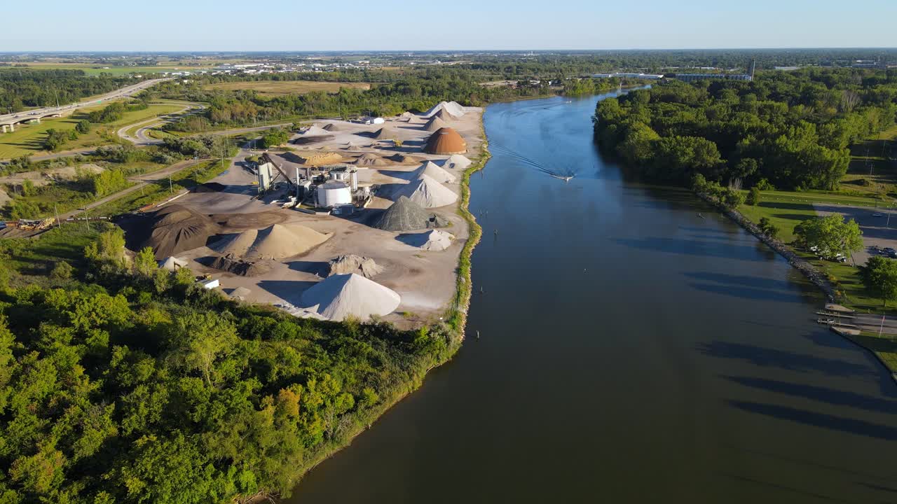 Piles of gravel material near Maumee river for shipping, aerial drone view