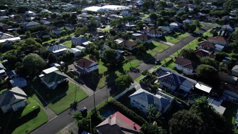 revealing drone shot over brisbane suburbs with the ocean in the background in queensland, australia