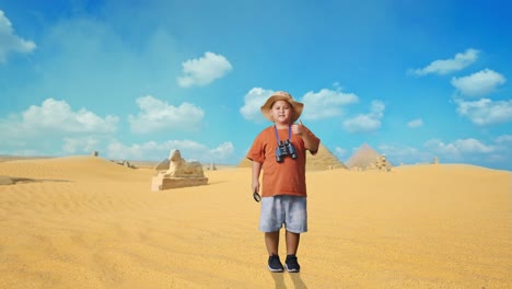 asian boy with a hat and binoculars showing magnifying glass and thumbs up gesture to camera. boy researcher examines something while traveling in giza pyramid, travel adventure, full body
