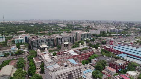 aerial reveal shot of government hospital, southern railway headquarters, and mgr central railway station in chennai tamil nadu, daytime , 4k, drone shot