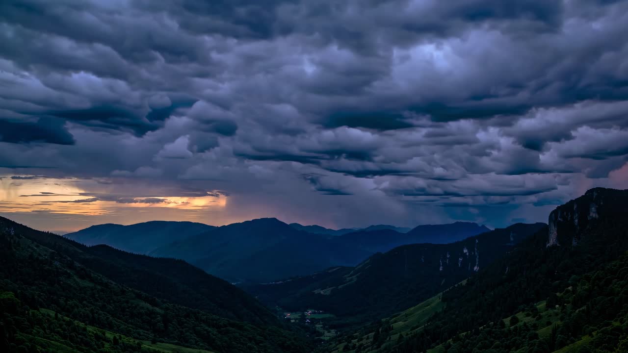Dramatic landscape video with a wide-angle view of rolling hills under a moody, cloud-filled sky