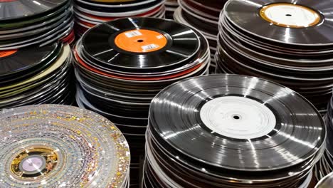 a pile of vinyl records stacked on top of each other