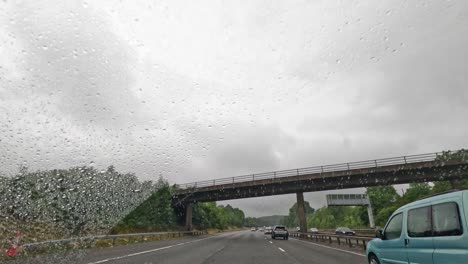 vehicles on wet road under cloudy skies