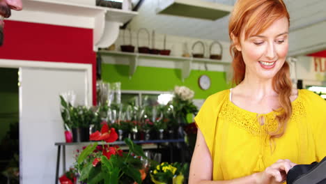 female florist using credit card terminal