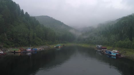 aerial view of a lake in the forest with fog