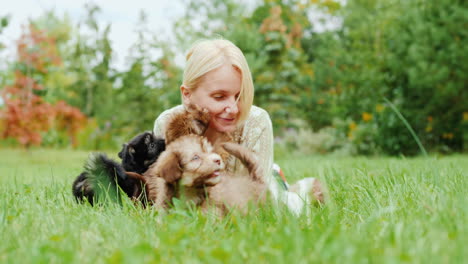 woman playing with puppies