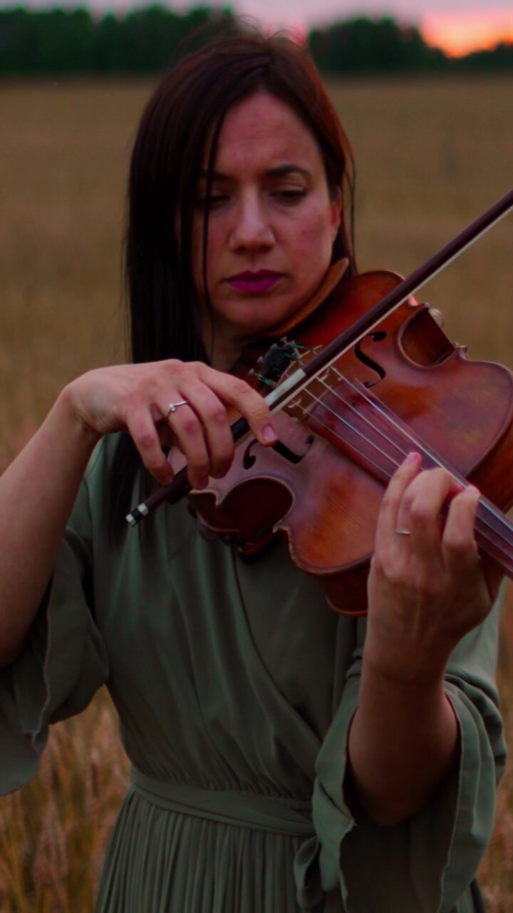 Woman Playing Violin in a Wheat Field at Sunset