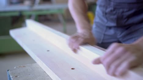 hands working on wood in a workshop