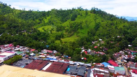 tilt down drone shot of a mountain down to market place