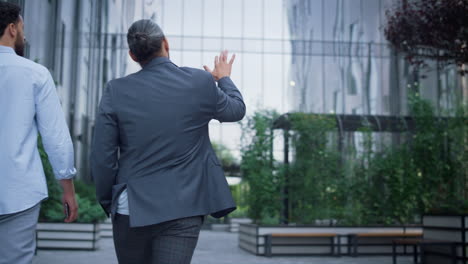 business people walking downtown district discuss modern futuristic architecture