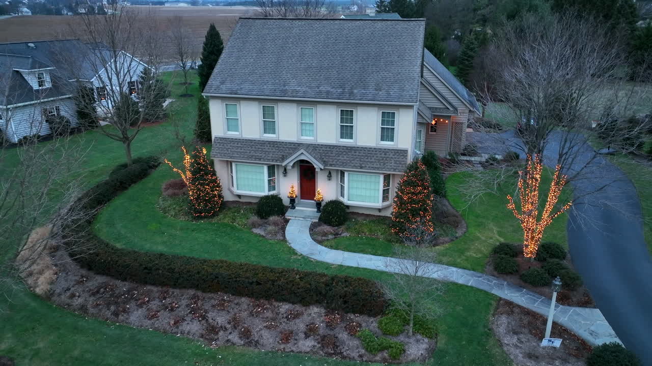Single family home decorated with pretty Christmas lights
