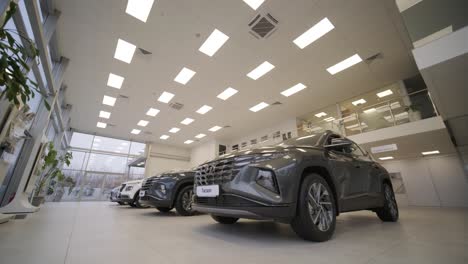 car dealership with row of anonymous new vehicle on sale. showroom with shiny auto. automotive