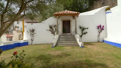 very beautiful doors with short cut grass in one of many houses in castle of óbidos