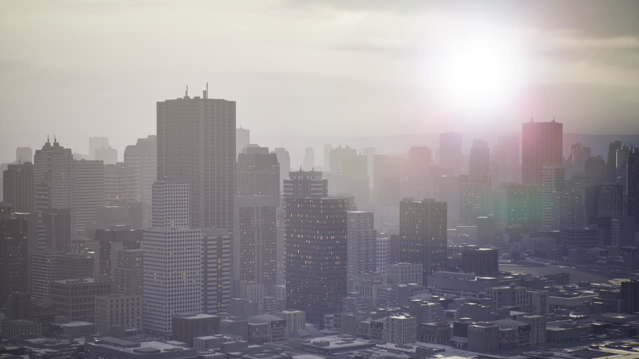 Sunrise over a city skyline bathed in mist and soft light