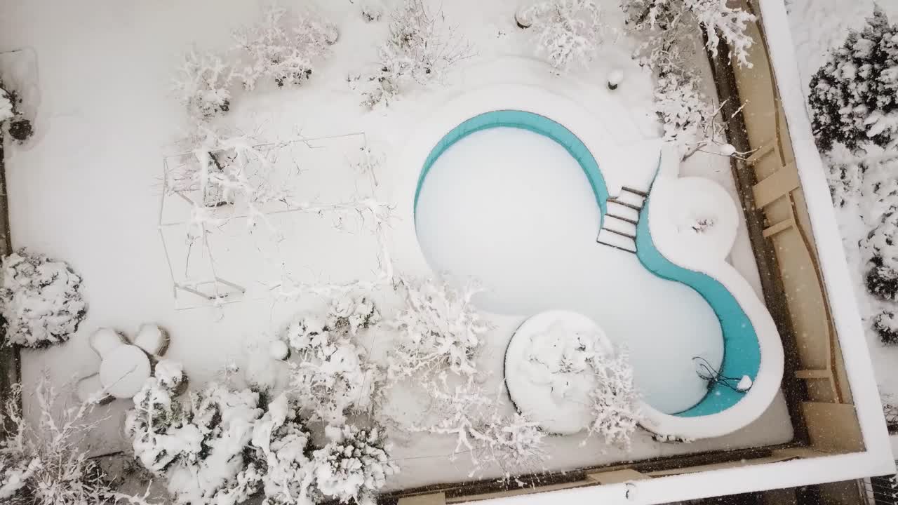 추운 겨울에 폭설이 내리는 동안 이란 테헤란의 한 집에 있는 푸른 수영장