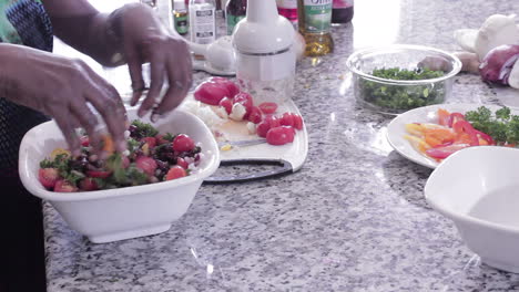 mixing salad together with hands